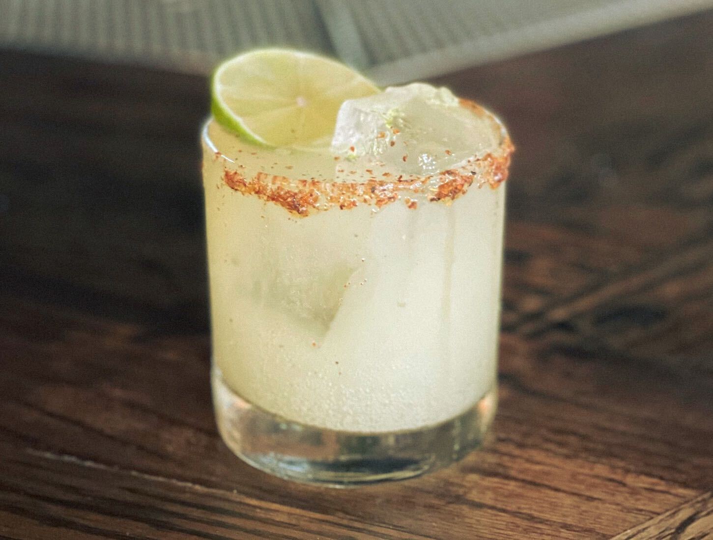 Close up shot of hands holding a can of Better Booch Guava Cooler Kombucha made with organic green tea